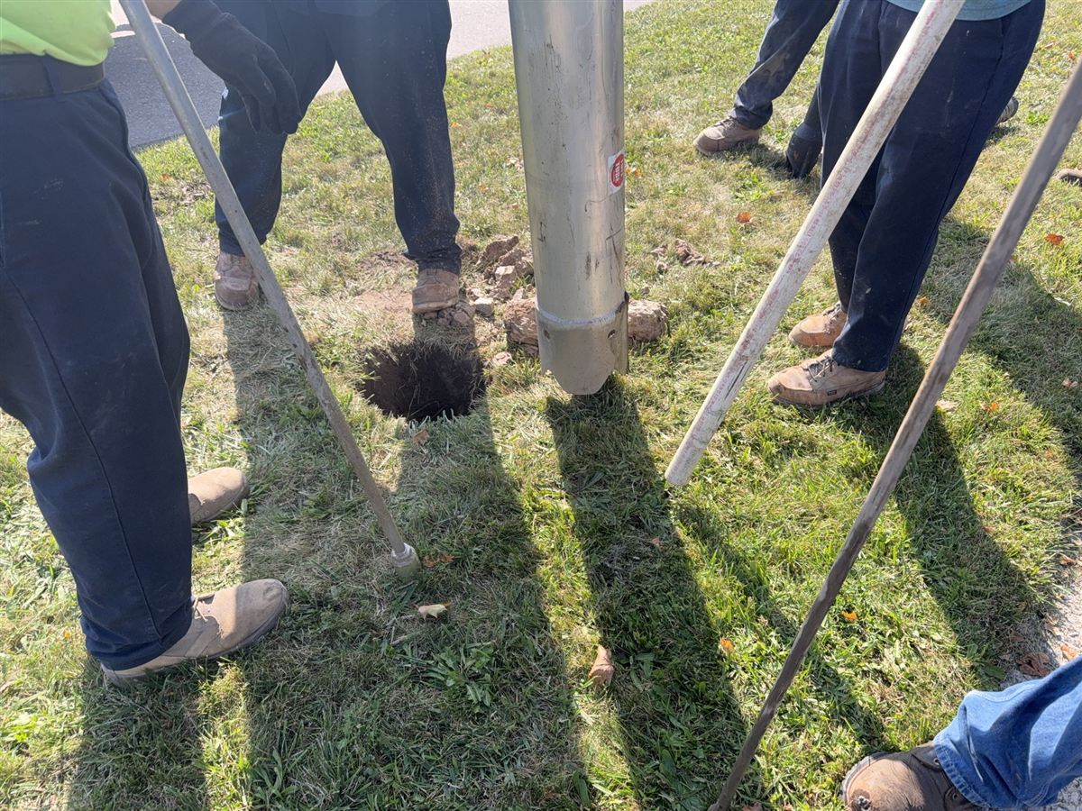 Fast Fencing Michigan crew installing fence posts with auger